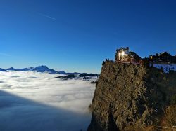 hotel on the edge of a cliff above clouds in avoriaz