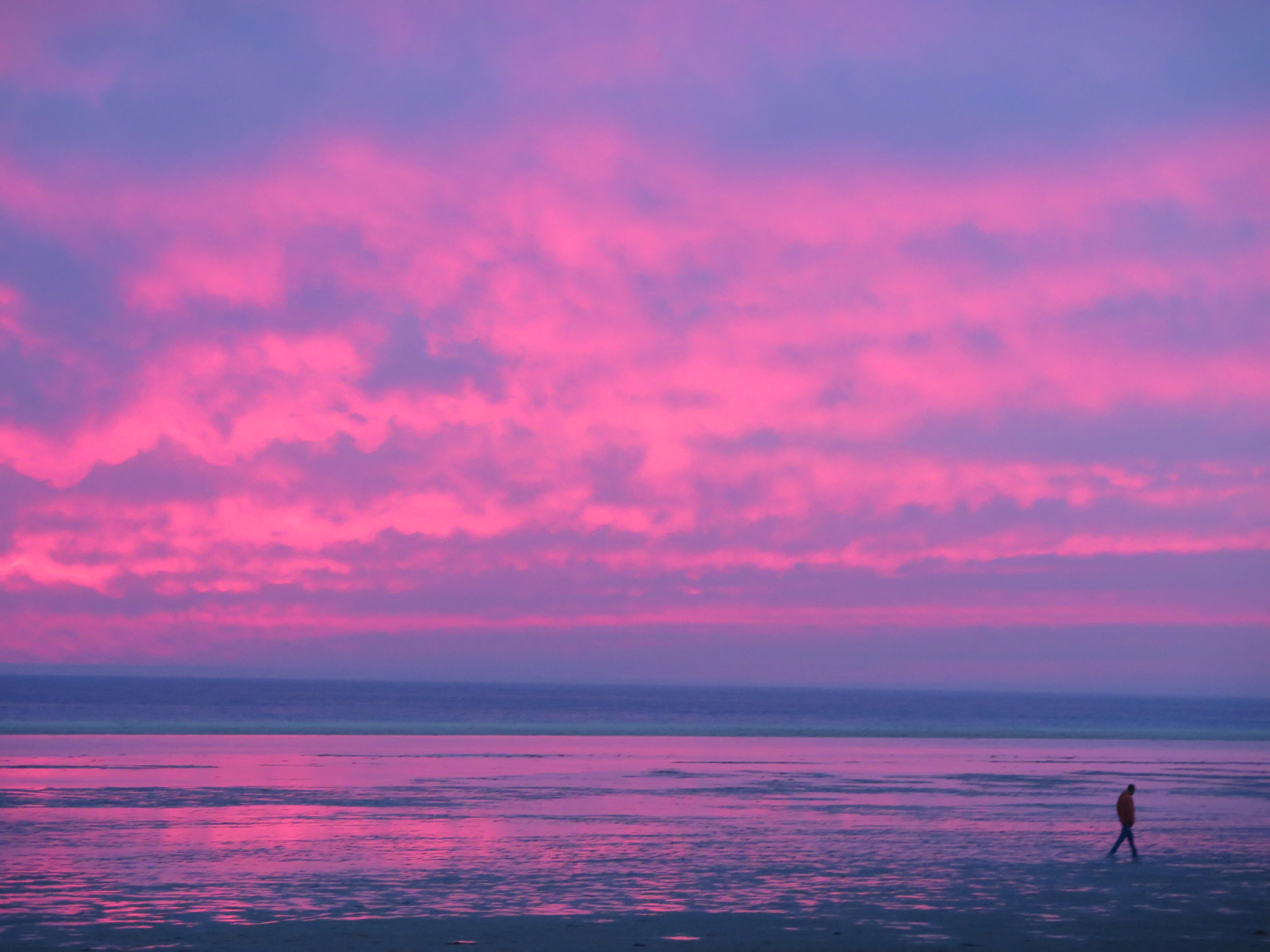 Tarifa sunset with walker on the beach